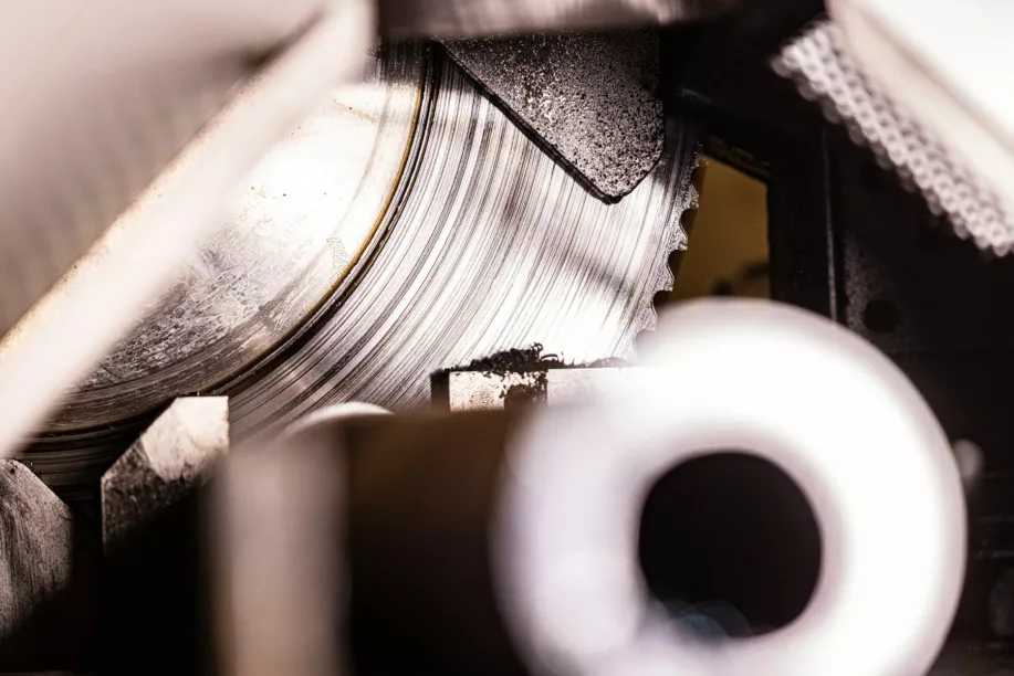 Production-Saw-min Production saw cutting through metal pipe