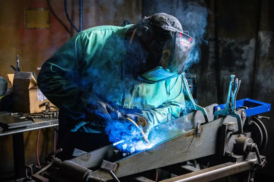 Welding-min Man welding in welding mask